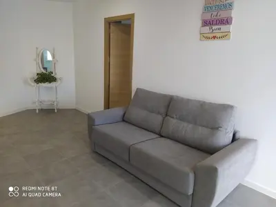 a gray couch sitting in a living room at Apartamento la antigua via in Bonanza