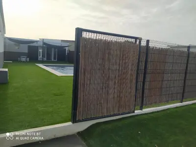a metal fence in a yard next to a lawn at Apartamento la antigua via in Bonanza