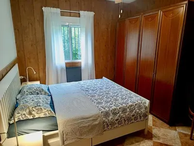 a bedroom with a bed and a dresser and a window at Del Sol 18 in Chiclana de la Frontera
