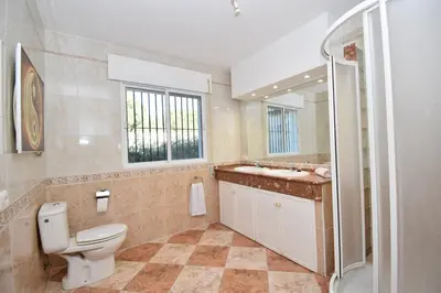 a bathroom with a toilet and a sink and a shower at Del Sol 18 in Chiclana de la Frontera