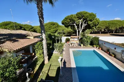 an external view of a house with a swimming pool at Del Sol 18 in Chiclana de la Frontera