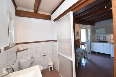 a bathroom with a toilet and a sink in a room at Del Sol 18 in Chiclana de la Frontera