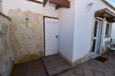 a room with a white door and a stone wall at Del Sol 18 in Chiclana de la Frontera