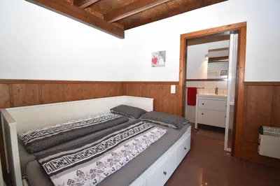 a bedroom with a bed in a room with a mirror at Del Sol 18 in Chiclana de la Frontera