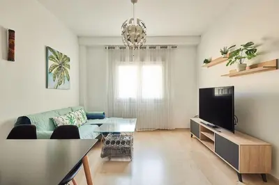 a living room with a couch and a tv at El Palmeral Ha Free Parking in Cádiz