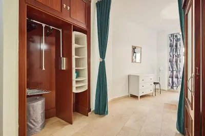 a room with a closet with green curtains and a dresser at El Palmeral Ha Free Parking in Cádiz