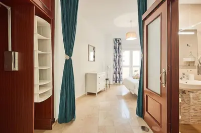 a bathroom with a sink and a bed in a room at El Palmeral Ha Free Parking in Cádiz