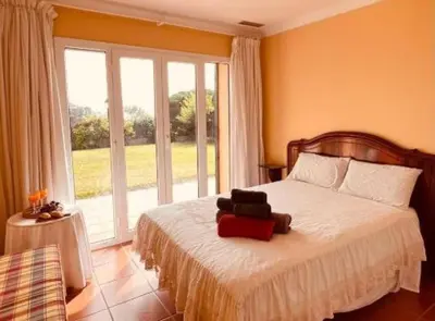 a bedroom with a bed with a teddy bear on it at Chalet Puerto Sherry in El Puerto de Santa María