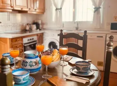 a kitchen table with glasses of orange juice on it at Chalet Puerto Sherry in El Puerto de Santa María