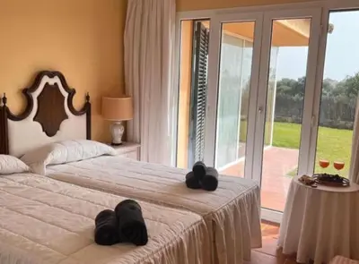 a bedroom with two beds with black towels on them at Chalet Puerto Sherry in El Puerto de Santa María