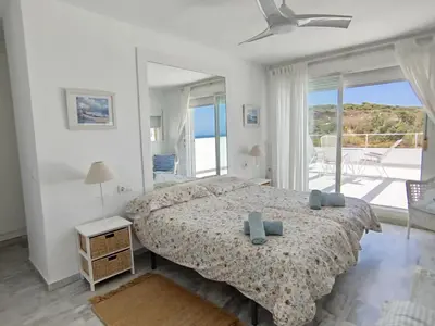 a bedroom with a bed with a view of the ocean at Conil Beach View Front House - Espectacular Casa con Vistas al Mar y acceso directo a la Playa in Conil de la Frontera