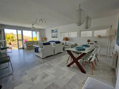 a living room with a couch and a table at Conil Beach View Front House - Espectacular Casa con Vistas al Mar y acceso directo a la Playa in Conil de la Frontera