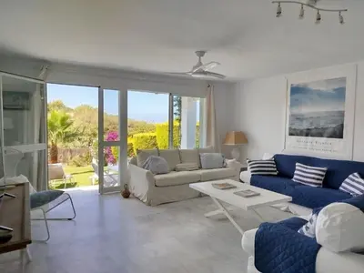 a living room with a couch and a table at Conil Beach View Front House - Espectacular Casa con Vistas al Mar y acceso directo a la Playa in Conil de la Frontera