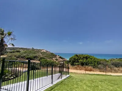 a fence with the ocean in the background at Conil Beach View Front House - Espectacular Casa con Vistas al Mar y acceso directo a la Playa in Conil de la Frontera
