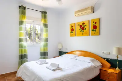 a bedroom with a bed and a window at Frambuesa by Cádiz Time in Chiclana de la Frontera