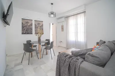 a living room with a couch and a table at Sibs Sanlucar Altamar Nuevo Centrico Tranquilo in Sanlúcar de Barrameda