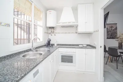 a kitchen with white cabinets and a sink at Sibs Sanlucar Altamar Nuevo Centrico Tranquilo in Sanlúcar de Barrameda