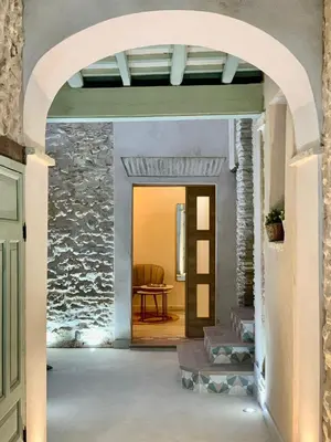 an archway leading into a room with a stone wall at Pimenium 318 in Medina Sidonia