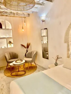 a bedroom with a bed and two chairs and a table at Pimenium 318 in Medina Sidonia
