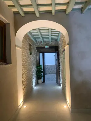 an archway in a building with a potted plant at Pimenium 318 in Medina Sidonia