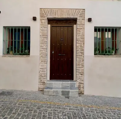 a brown door on the side of a building at Pimenium 318 in Medina Sidonia