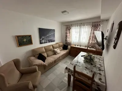 a living room with a couch and a table at Apartamento Condesa in Sanlúcar de Barrameda