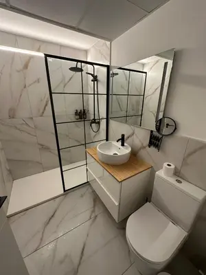a white bathroom with a toilet and a sink at Apartamento Condesa in Sanlúcar de Barrameda