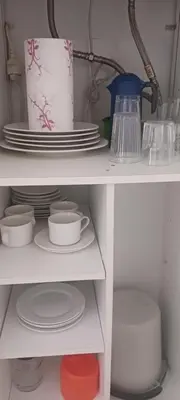 a white shelf with dishes and plates and a blender at El Brujo in Jerez de la Frontera