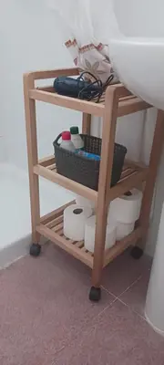 a shelf with toilet paper on it next to a sink at El Brujo in Jerez de la Frontera