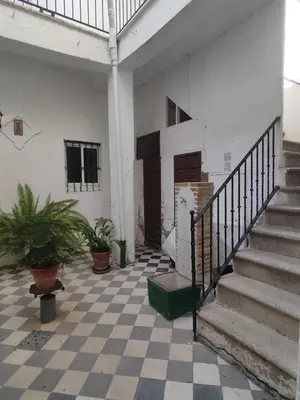 a room with a staircase and a checkered floor at El Brujo in Jerez de la Frontera