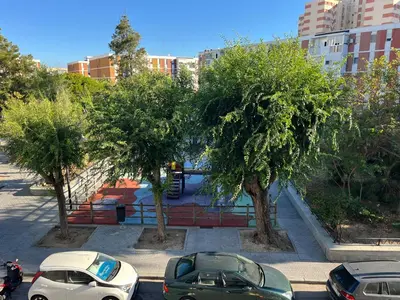 a group of cars parked in a parking lot with trees at Piso en Cadiz para Verano in Cádiz