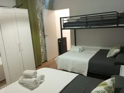 a bedroom with two beds and a bunk bed at La parada in El Puerto de Santa María