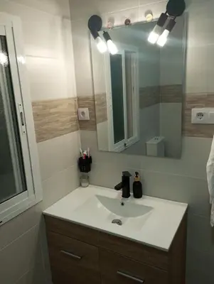 a bathroom with a sink and a mirror at La parada in El Puerto de Santa María