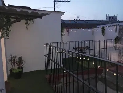 a balcony with a wrought iron fence with lights at La parada in El Puerto de Santa María