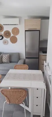 a kitchen with a white table and two chairs at Casita de diseño cerca del mar in El Puerto de Santa María