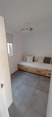 a room with a bed in the corner of a room at Casita de diseño cerca del mar in El Puerto de Santa María