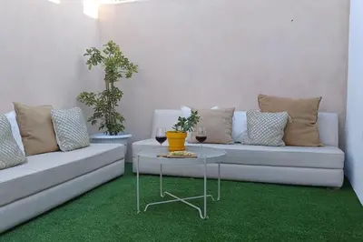 a living room with a couch and a table with wine glasses at Casita de diseño cerca del mar in El Puerto de Santa María