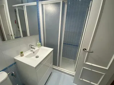 a bathroom with a shower and a sink and a toilet at Apartamento Centro Chipiona La Perla in Chipiona