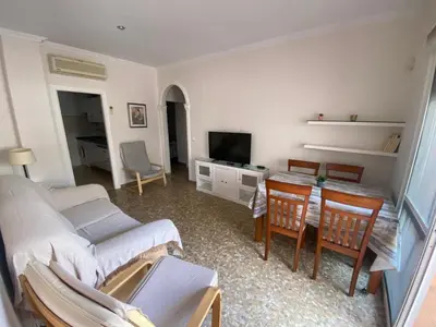 a living room with a couch and a table at Apartamento Centro Chipiona La Perla in Chipiona