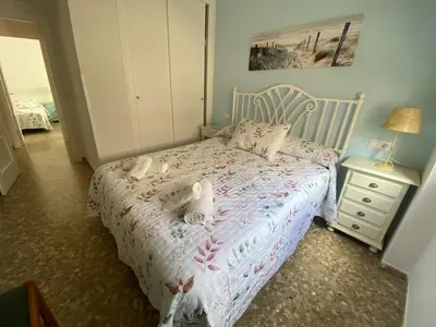 a bedroom with a bed with two dolls on it at Apartamento Centro Chipiona La Perla in Chipiona
