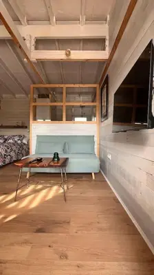 a room with a blue couch and a table at La Casita in Cuartillos