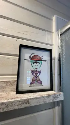 a picture in a picture frame on a shelf at La Casita in Cuartillos