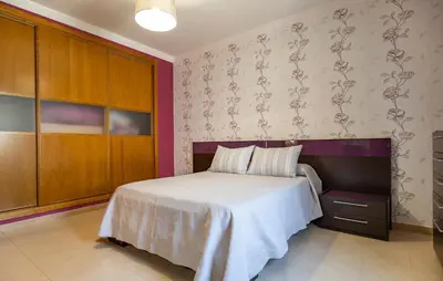 a bedroom with a white bed and a wall at Nice Home In Arcos De La Frontera in Arcos de la Frontera