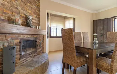a dining room with a fireplace and a table and chairs at Nice Home In Arcos De La Frontera in Arcos de la Frontera