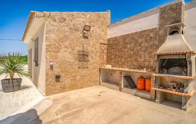 a kitchen with a brick wall and a stove at Nice Home In Arcos De La Frontera in Arcos de la Frontera