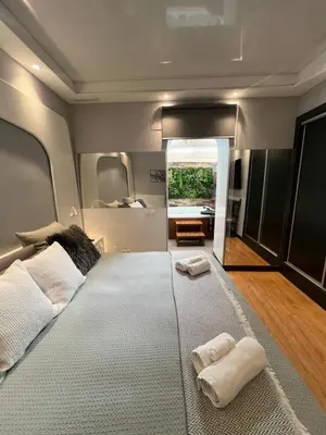 a bedroom with a large bed with two towels on it at BASTINAZO ALOHADREAM - EXCLUSIVO - Design Suite Luxury Love and Spa - Jacuzzi y Sauna Privados in El Puerto de Santa María
