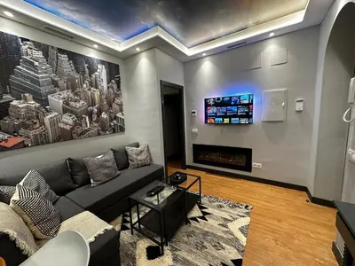 a living room with a couch and a tv at BASTINAZO ALOHADREAM - EXCLUSIVO - Design Suite Luxury Love and Spa - Jacuzzi y Sauna Privados in El Puerto de Santa María