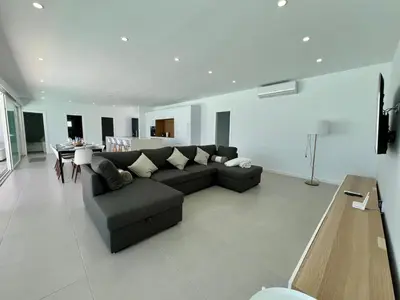 a large living room with a couch and a table at El Nirvana in Chiclana de la Frontera