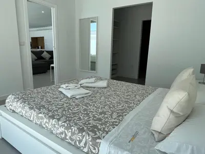 a bedroom with a bed with two towels on it at El Nirvana in Chiclana de la Frontera