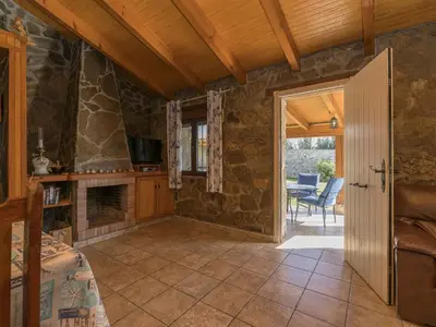 a bedroom with a fireplace and a table with chairs at Holiday Home De Piedra by Interhome in Conil de la Frontera
